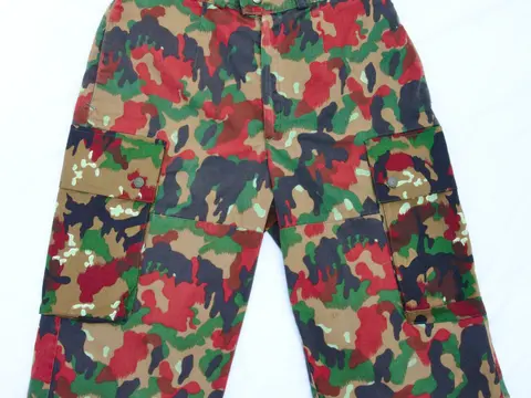 A pair of camouflage print cotton shorts lying flat on a white background.