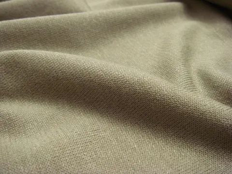 Draped khaki interlock jersey knit fabric with a soft fold.