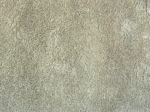 Close-up of pale terry towelling showing its dense uncut loops.